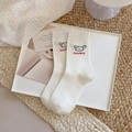 White cotton crew socks featuring cute cartoon puppy print and red Happy lettering - Happy Puppy Style