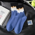 Klein blue athletic crew socks with zigzag patterns on a black leather background - Blue Wave Contrast Style