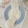 Cream-white mesh socks with heart pattern and black polka dot bow in a stylish display - One Size / White Button Bow