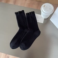 Black ribbed mid-calf socks with ruffle trim edge and soft cotton knit texture - One Size / Black