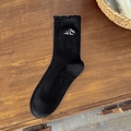 Black ribbed crew socks with scalloped edges and sweet bow embroidery on wood - Black Letter Embroidery Style