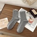 Classic grey mid-calf cable knit socks with stylish egg label on a dark wood surface - One Size / Light Gray