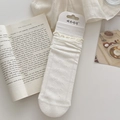 White cotton mid-calf socks with lace ruffle trim and knitted bow patterns - Moonlight White