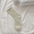 Light green cotton mesh crew socks with ribbed texture and minimalist rolled cuffs - Green