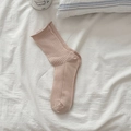 Chic cream mesh crew socks with rolled edges and vertical ribbing on a cozy bed - Brown