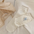 White crew socks with blue bow embroidery on soft textured fabric background - Blue Embroidered Bow
