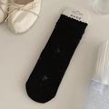 Elegant black mid-calf socks with lace floral patterns and delicate ruffle trim details - Mystic Black