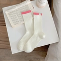 Women's white vertical ribbed crew socks with pink trim and small cartoon woven label - One Size / White with Rose Red Cuff