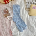 Light blue ribbed knit crew socks with white horizontal stripes on white fabric - One Size / Blue