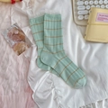 Mint green striped crew socks with ruffled cuffs and cotton knit texture in flat lay - One Size / Green