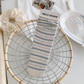Light beige cotton socks with blue stripes and colorful speckles on metal basket - Blue Stripe