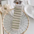 Off-white and olive green striped crew socks with colorful flecks and roll-top detail - Green Stripes