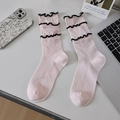 Light pink crew socks with black ruffled edges and vertical ribbed cotton texture - One Size / Pink