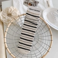 Off-white cotton crew socks with black stripes and colorful speckles in a basket - Dark Gray Stripes