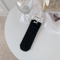 Sweet black crew socks with white lace trim and bow accent in a flat lay display - Black Bow