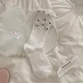 White polka dot crew socks with ruffled cuffs and ribbed texture for women - One Size / White