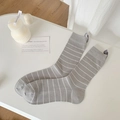 Light gray crew socks with white stripes and breathable mesh texture in lifestyle setting - Horizontal Stripe Grey with Label