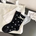 Ballet style black mid-calf socks featuring white heart patterns and ribbon bow accents - Black