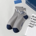 Grey and navy knit men's socks featuring yellow smiley face and UP letter patterns - UP Letters / Gray