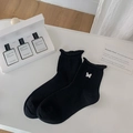 Black cotton socks featuring white butterfly embroidery and elegant ruffled cuff edges - One Size / Black