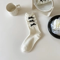 Cream white mid-calf socks with black ribbon bows and delicate ruffled edges - White with Black Bow