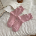 Chic lotus pink crew socks with colorful speckles and woven side label on soft blanket - One Size / Pink