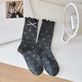 Dark grey crew socks with ruffle edges and white bow patterns in a cute aesthetic - One Size / Dark Grey Bow (1 Pair)