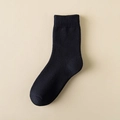 Thick knit mid-calf winter sock in black with elastic ribbed cuffs and solid texture - Black
