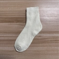 Thick cream mid-calf thermal terry sock with ribbed cuffs on dark wood background - Milky Yellow