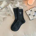 Thick charcoal grey wool socks with white bow embroidery in a cozy winter setting - One Size / Dark Gray