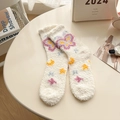Plush cream coral fleece mid-tube socks with butterfly and moon patterns in cozy warm setting - Off White