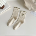 Cream knit mid-calf socks with colorful speckles and green scalloped edges with a bow - Green Bow
