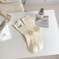 Cream white mid-calf knit socks featuring a silver glitter bow and ruffled lace edge - One Size / Off-white