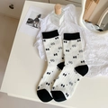 White crew socks with black bow patterns and ribbed cotton texture for women - One Size / White with Bowknot