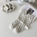 Beige crew socks for women featuring small black bow prints and ribbed elastic cuffs - Black Bow Pattern / Beige