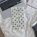 Japanese style cream white crew socks featuring black bow prints and ruffled edges - White with Bowknot