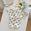 Chic off-white cotton mid-calf socks featuring black bow patterns and ruffled cuffs - All-over Bowknot Style