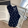 Black mid-calf knit socks with white bow patterns and a sparkling rhinestone bow detail - One Size / Black