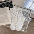 White crew socks with gray bow prints and a 3D bow featuring a sparkling gemstone charm - One Size / White
