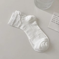 White cotton mesh socks with delicate ribbon bows and ribbed texture in minimalist style - White