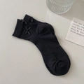 Black ribbed cotton crew socks with side bow ribbons for women in minimalist layout - Black