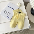 Light yellow ribbed crew socks with black H-letter embroidery on a white background - One Size / Yellow