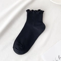 Women's black ruffled ankle socks featuring stylish ribbed texture and frilly lettuce edges - One Size / Black