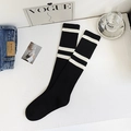 Knee-high black cotton socks with white stripes and ribbed texture in flat lay style - One Size / Black (White Striped)