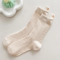 Beige ribbed mid-calf socks featuring a cute smiley face woven label and thick knit texture - Beige