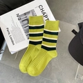 Green mid-calf cotton socks with black and white stripes and ribbed cuffs on art magazine - Green Top Stripes (1 Pair)