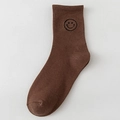 Deep brown cotton crew socks featuring a minimalist black knitted smiley face pattern - One Size / Brown