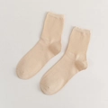 Solid beige cotton mid-calf socks with ribbed knit texture and comfortable fit - Nude