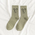 Olive green crew socks with embroidered cartoon sad face pattern made of soft cotton - One Size / Green