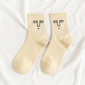 Mid-calf cotton socks in beige featuring a minimalist black grumpy face embroidery - One Size / Beige